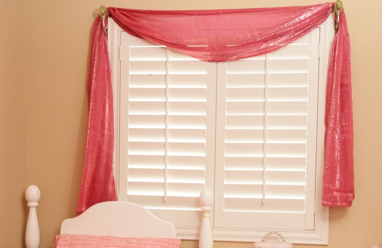 Kid's room with plantation shutters.